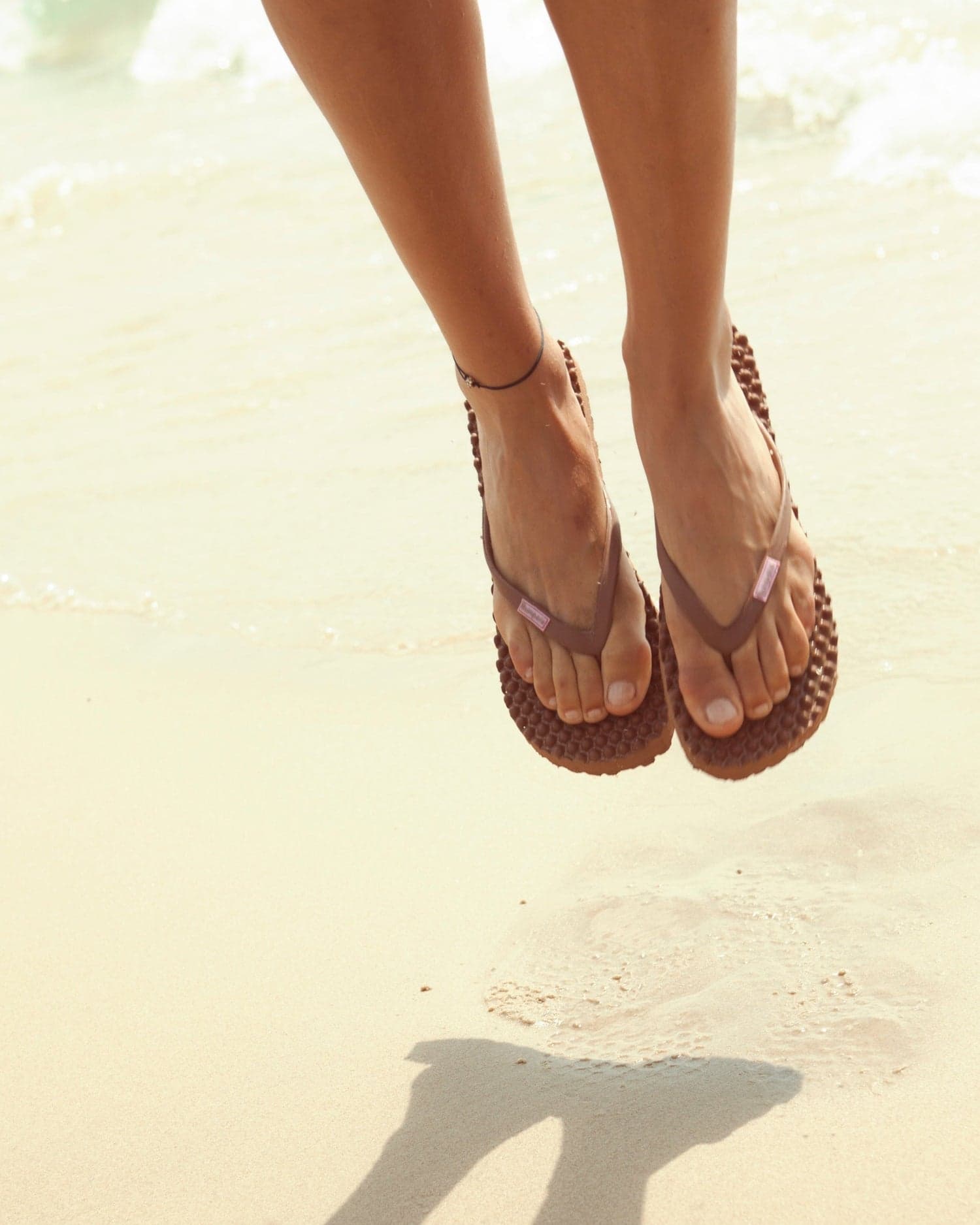 Bumpers footwear shown in a bright coastal setting